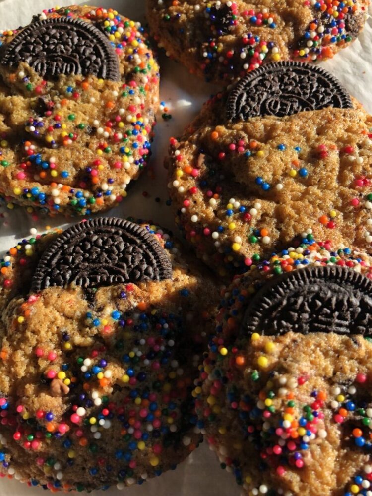double oreo confetti cookies with halves of oreos in each cooking sticking out in a way that looks like it's in the cookie's back pocket