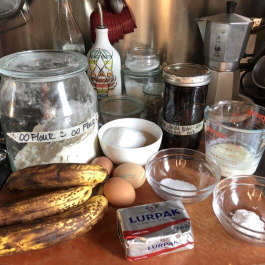 Classic southern banana bread ingredients on a cutting board on the countertop