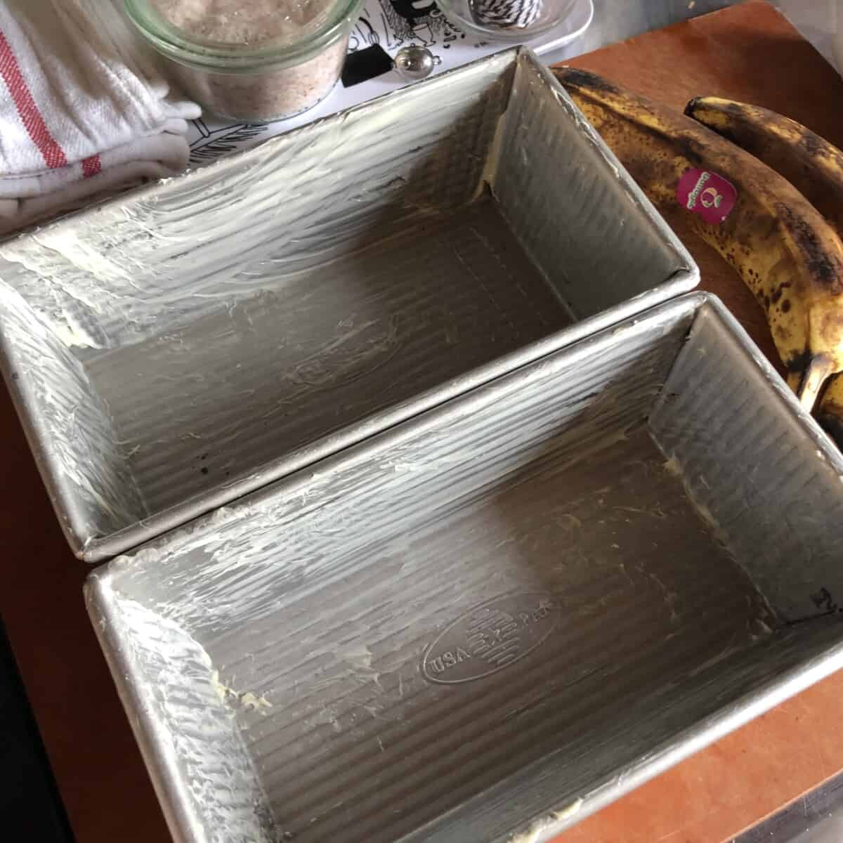 Two Buttered loaf pans.