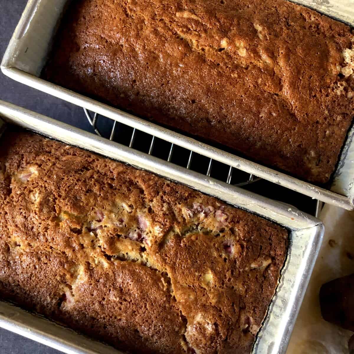 two loaves of banana bread on a cooling rack.