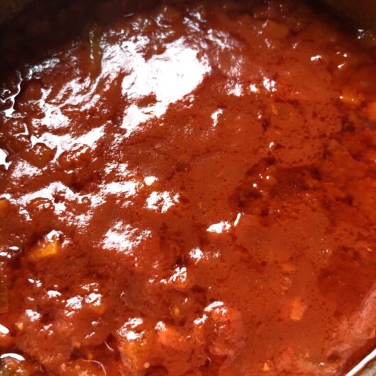deep and bright red glistening tomato pasta sauce in the pot