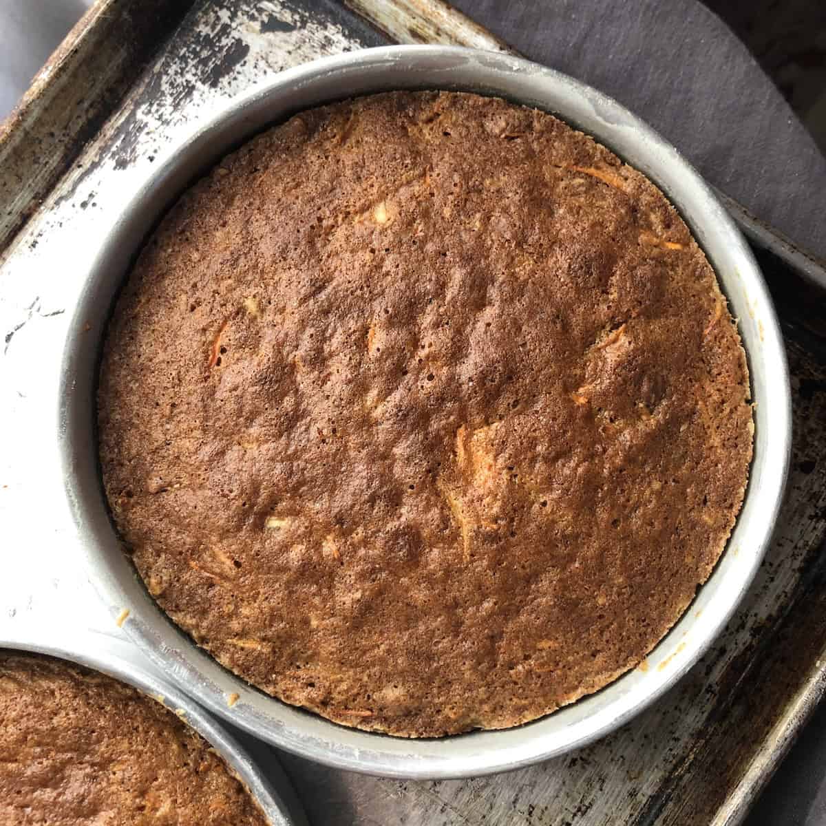 Two perfectly baked orange carrot cake layers with toasted pecans, lighter in color but just as moist - a small carrot cake recipe that works equally well as cupcakes or a carrot cake loaf.
