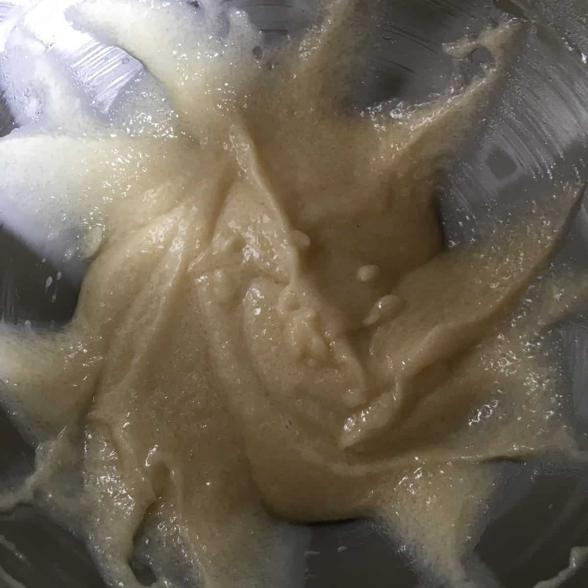 Butter, oil, applesauce, and sugar well combined in a stand mixer bowl, the creamed wet ingredients base for carrot cake batter and moist carrot cake.