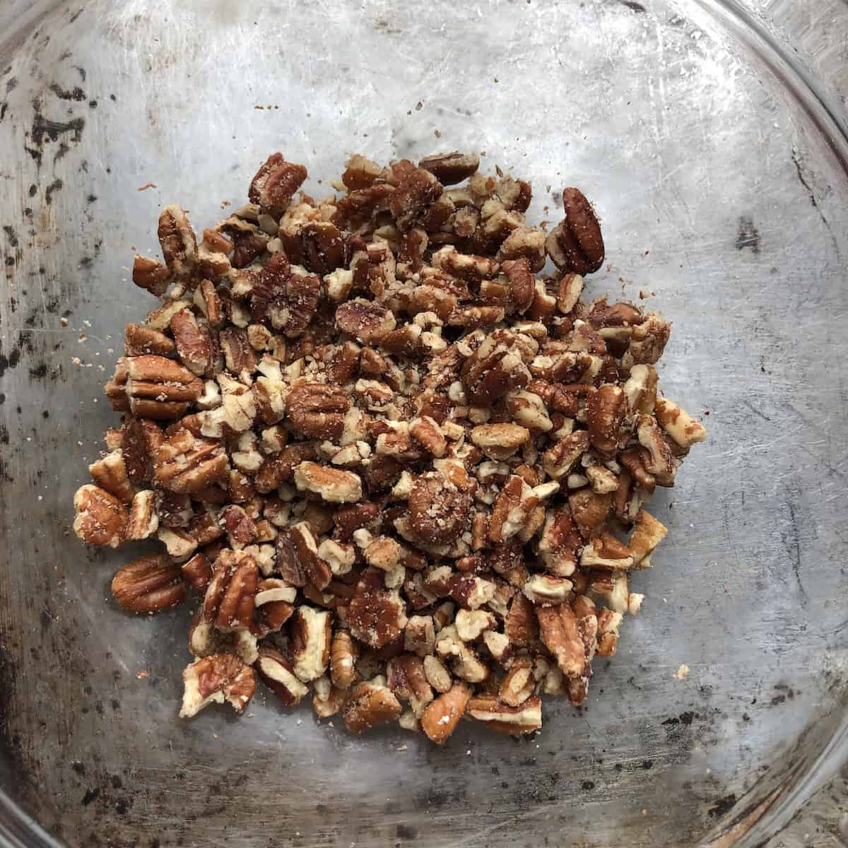 Freshly toasted pecans chopped and ready to fold into carrot cake batter for a moist carrot walnut cake recipe with deep nutty flavor.

