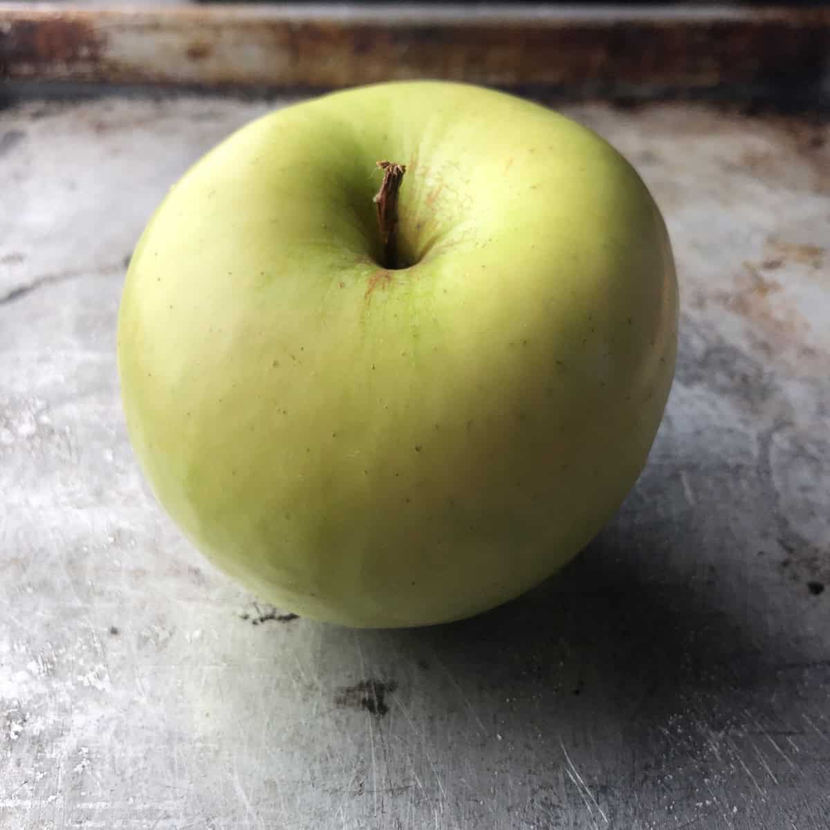 A Granny Smith apple for homemade applesauce - a secret ingredient that keeps this healthy carrot cake recipe incredibly moist without extra oil.