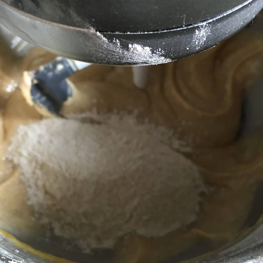 A fully cohesive carrot cake batter in a stand mixer bowl, smooth and ready for the freshly grated carrots to be folded in.
