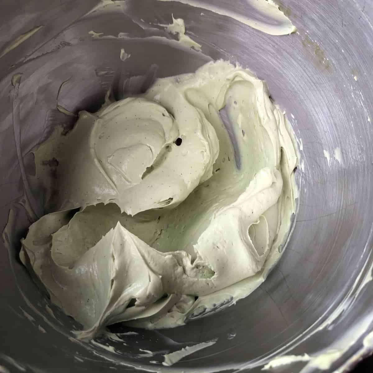Spring-green matcha cream cheese mascarpone frosting in a stand mixer bowl showing my best cream cheese frosting recipe for carrot cake. 