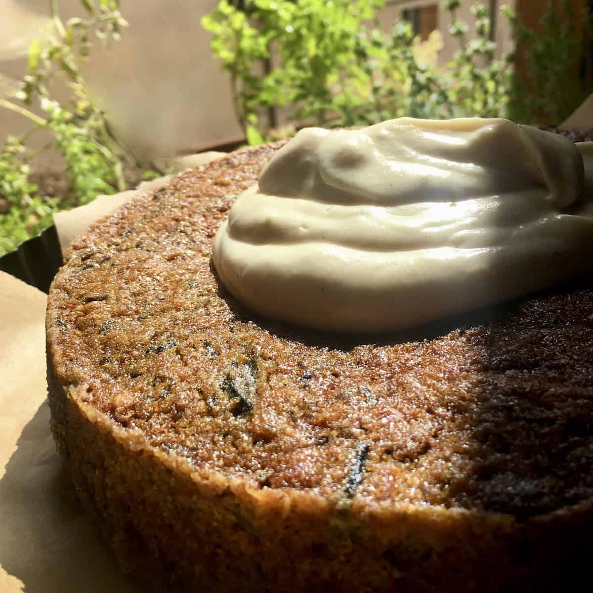 A super moist carrot cake crumb with walnuts, golden raisins, and purple and orange carrots, topped with a dollop of vanilla bean cream cheese frosting.