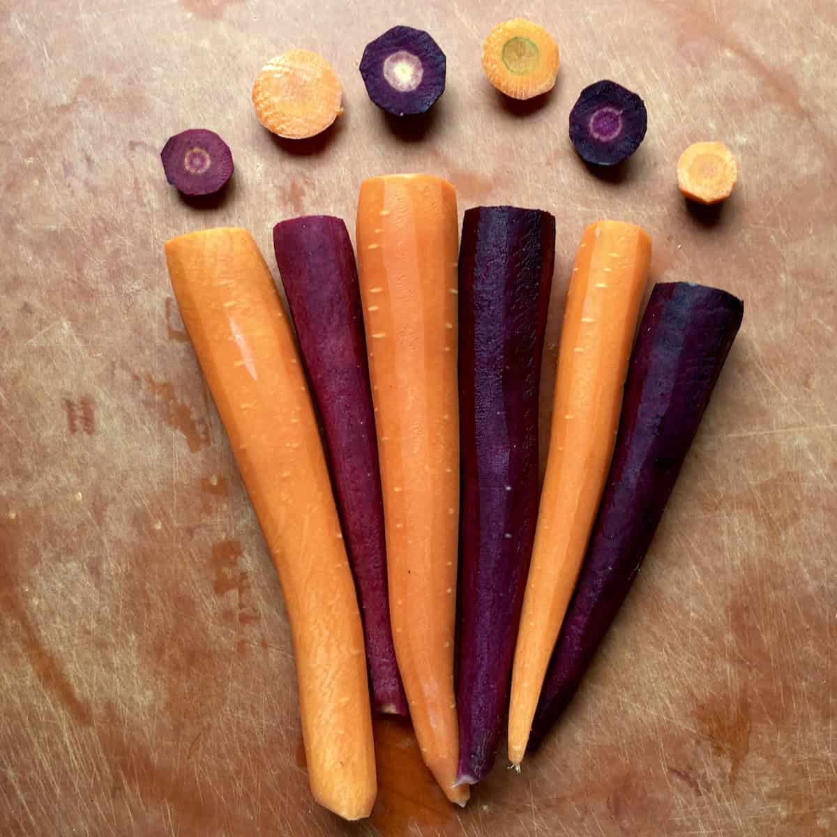Purple and orange carrots peeled and ready to grate for purple carrot cake.