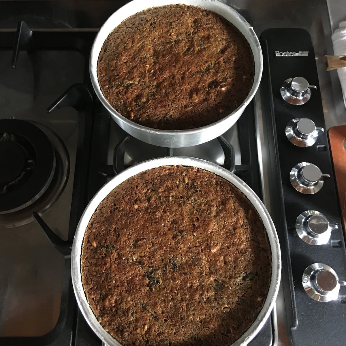 Two perfectly baked purple carrot cake layers with walnuts and raisins, slightly darker in color from the purple carrots and incredibly moist throughout.