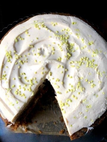 A classic homemade carrot cake recipe with raisins, purple carrots, orange carrots, toasted walnuts, and cream cheese frosting - award winning carrot cake with an incredibly moist crumb revealed in every slice.