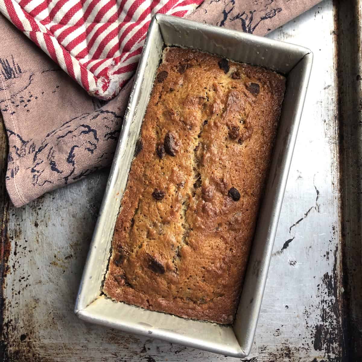 Baked strawberry banana bread cooling in the loaf pan for 15 minutes before turning out.
