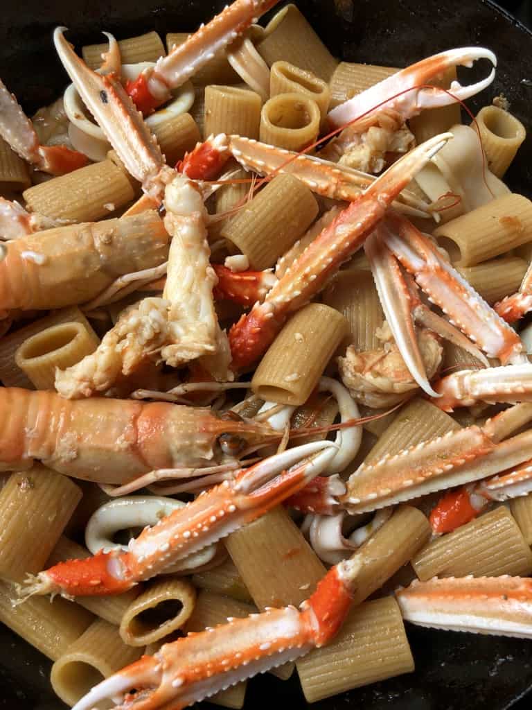 A cast iron skillet filled with Shrimp Scampi Pasta with Marsala Sauce.