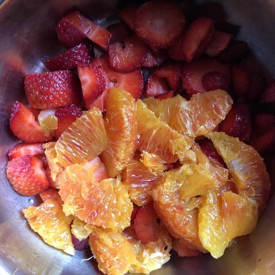 blood orange segments, strawberries in a small pot