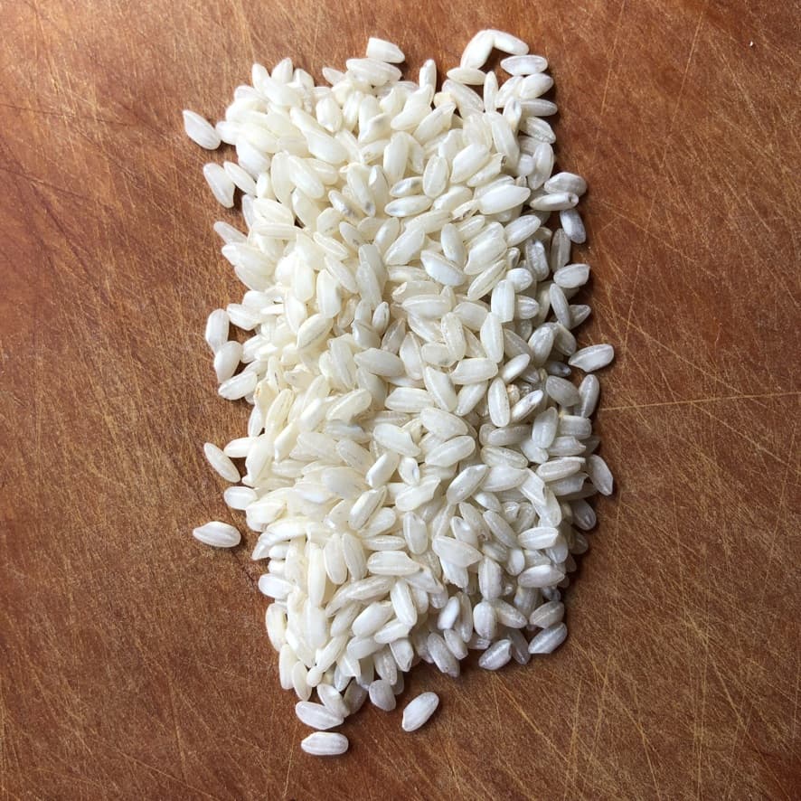 arborio rice kernels on a cutting board
