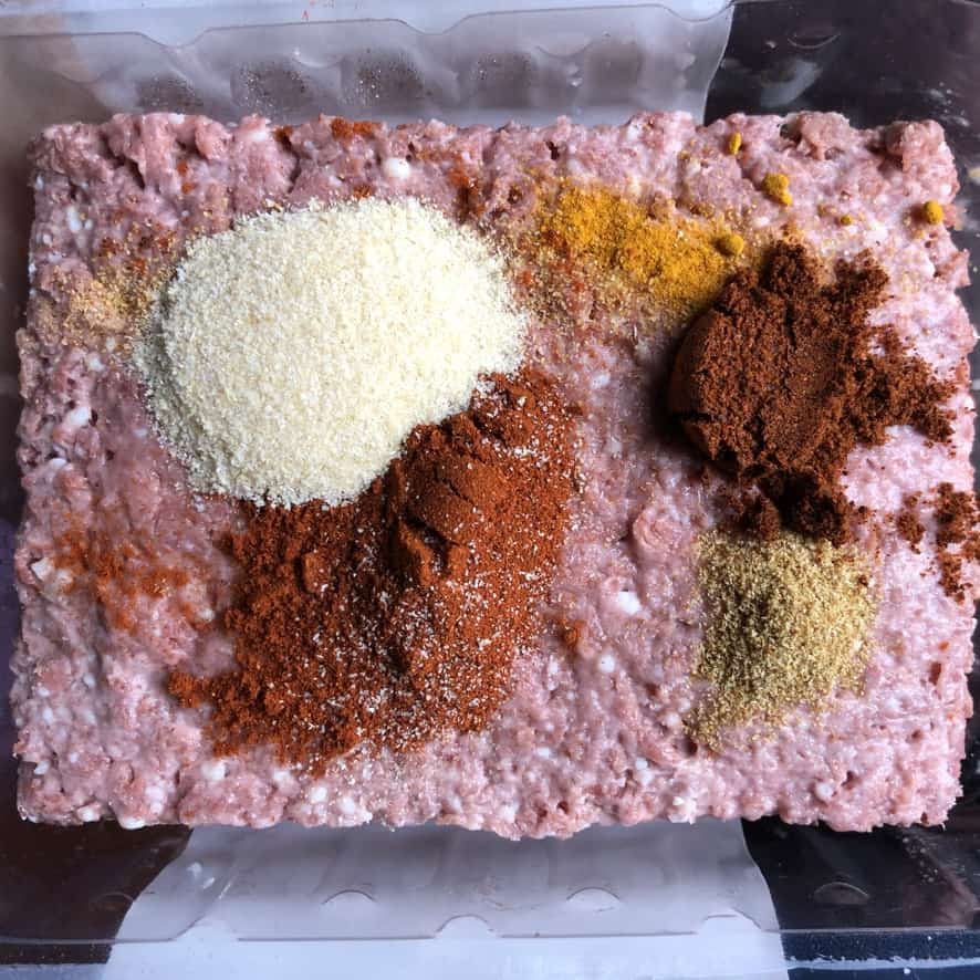 Beyond Mince "meat" rectangle in a bowl with spices on top before being mixed in