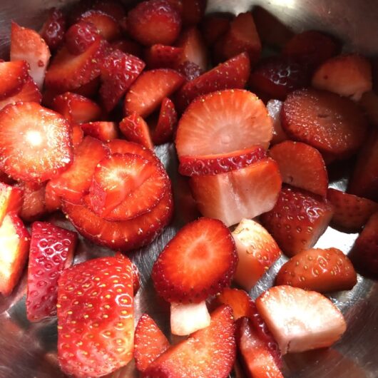 sliced ruby red strawberries in a pot