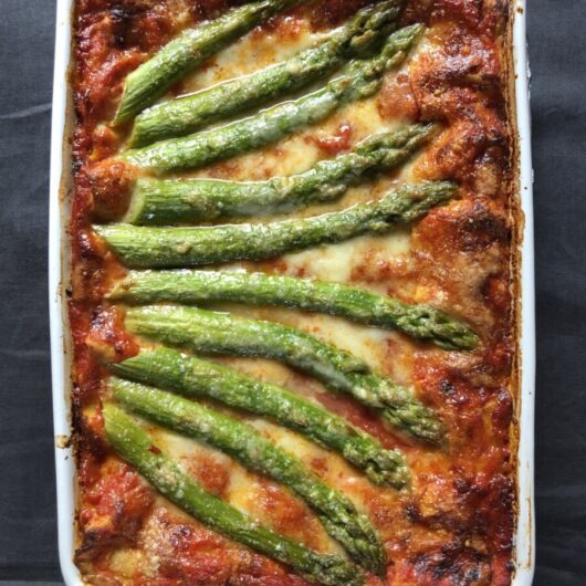fully baked and bubbling asparagus and speck lasagna