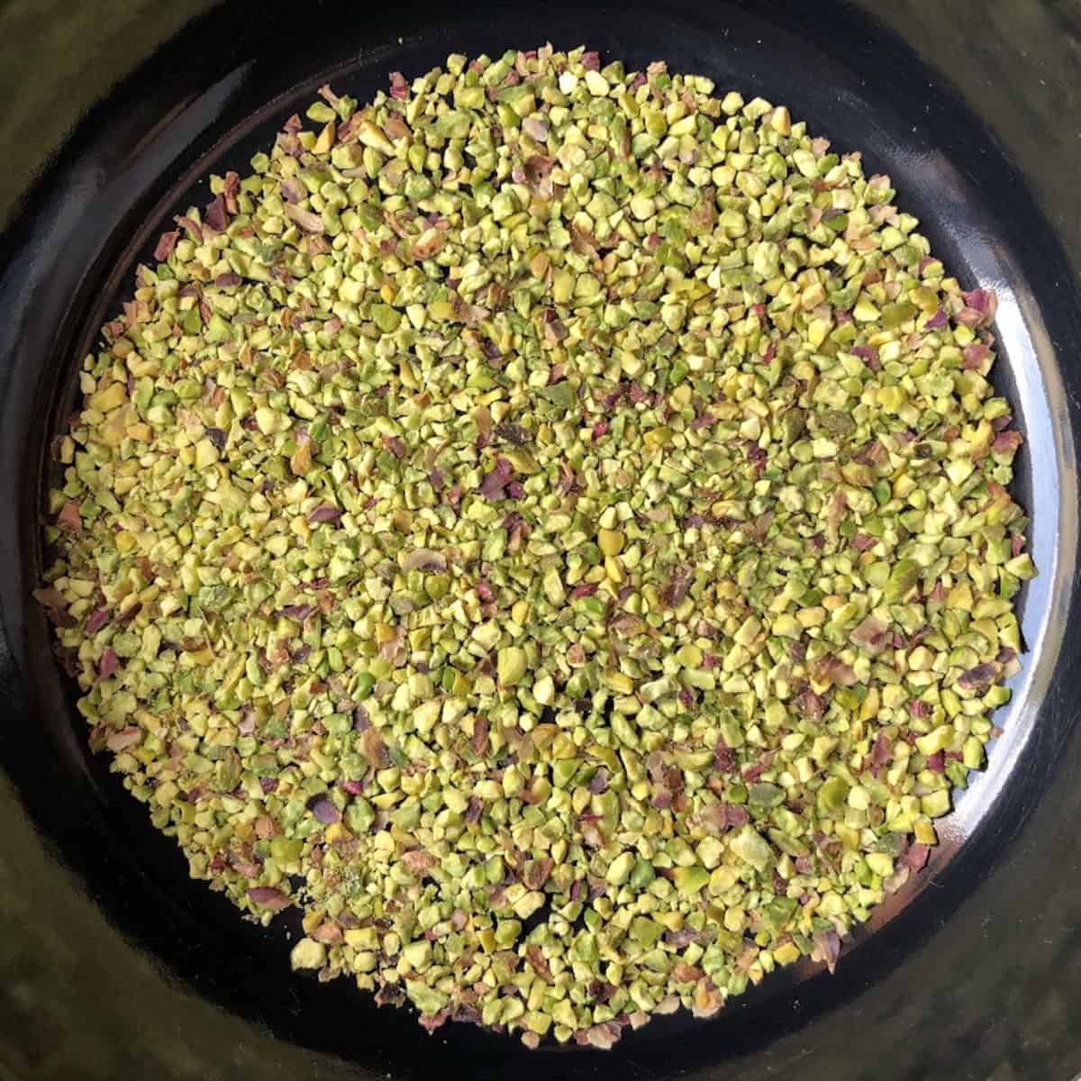 skillet-banana-nut-bread	Chopped pistachios toasting in a dry skillet for pistachio banana bread.
