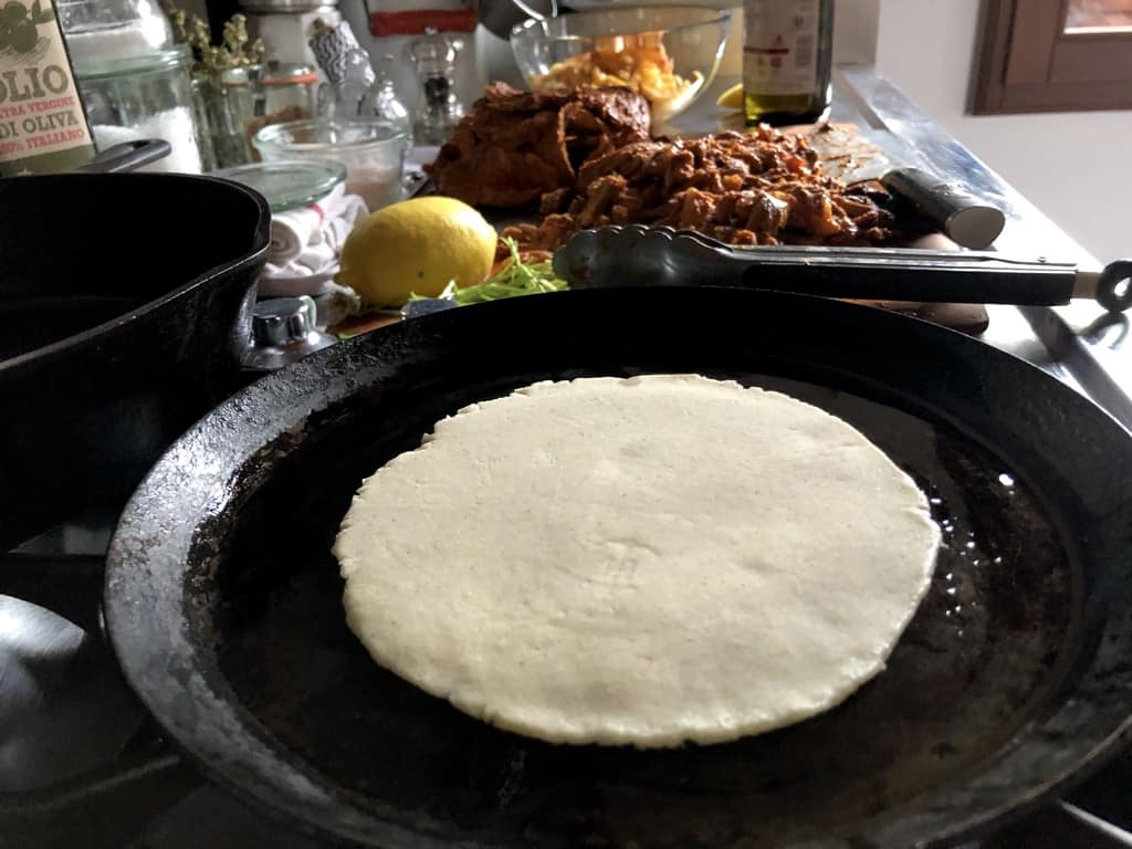 cooking a homemade corn tortilla on a de Buyer crepe pan