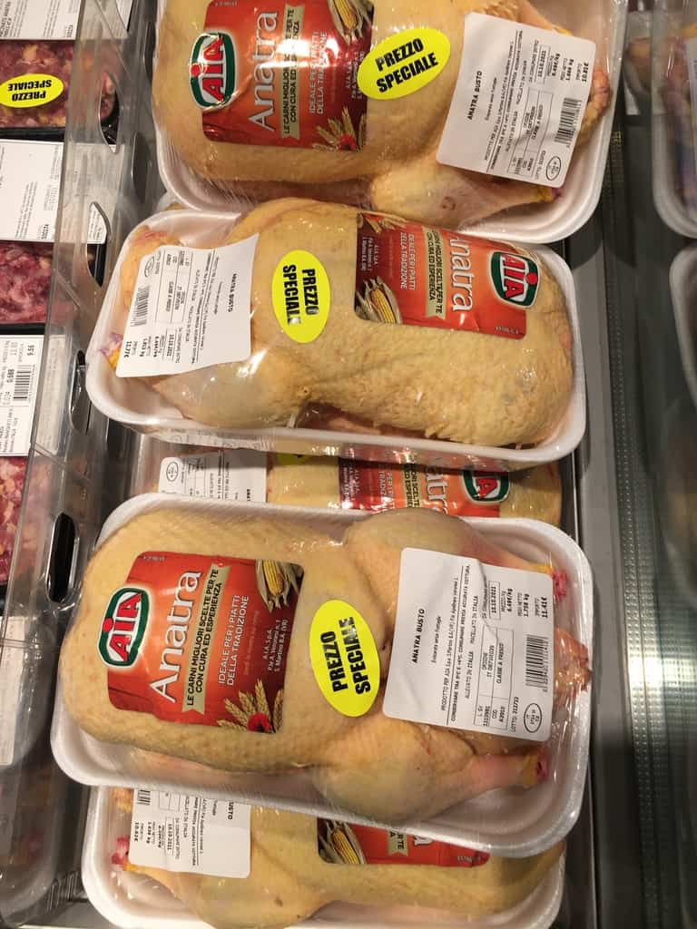 whole ducks in the cooler case at a local Italian supermarket
