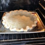 blind-baking the pie crust to get the bottom golden brown after removing the parchment with pie weights during the last five minutes of baking time