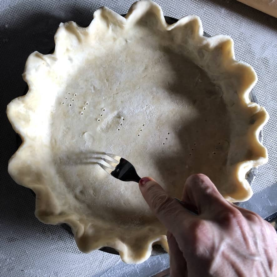 pricking holes in the pie dough
