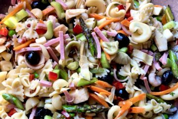 Mediterranean pasta salad with pasta, olives, fresh mozzarella, shrimp, sauteed asparagus and carrots, sun dried tomatoes, celery, cucumbers, and more.