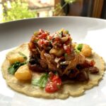 tacos al pastor on a homemade white corn tortilla with grilled pineapple and salsa