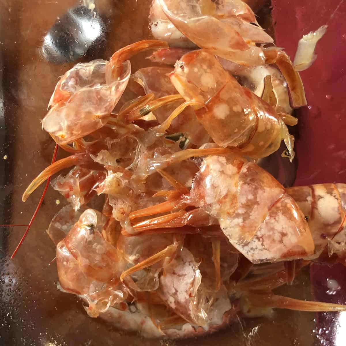Shrimp heads and tails removed so they can be used to make a quick shrimp stock for risotto, or use it to make shrimp butter.