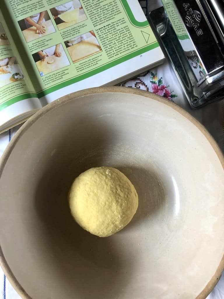 a more well-formed and kneaded dough round of homemade pasta but still rough on the surface