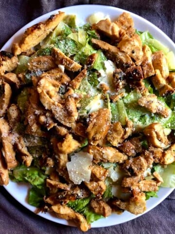 chicken ceasar salad on a large round platter