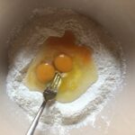using a fork to break up the eggs before starting to incorporate them into the flour