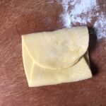 a piece of pasta dough folded like a letter