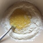 starting to incorporate the whisked eggs into the flour slowly
