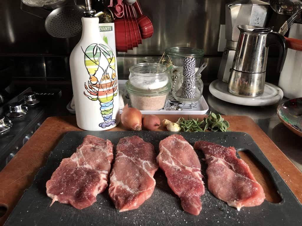 pan seared pork shoulder steaks ingredients on a cutting board