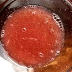 setting aside some of the strawberry juice
