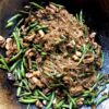 a wok filled with beautifully brown glass fettuccine noodles, tender slivers of pork and garden fresh green beans