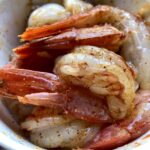 raw seasoned and lightly oiled shrimp with tails on