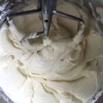 creamed sugar and philadelphia cream cheese in the bowl of a stand mixer with paddle attachment