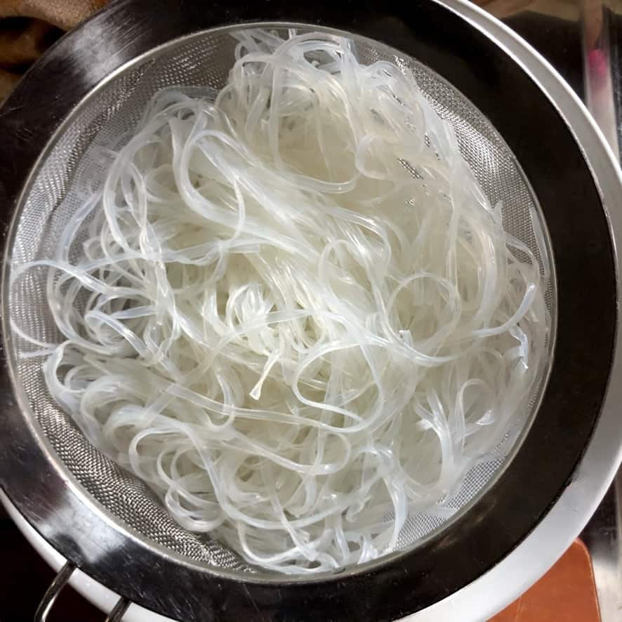 mung bean noodles after cooking, rinsed, and strained still resting in the sieve