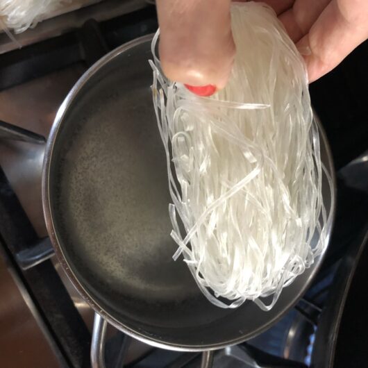 adding mung bean noodles to the just boiled water