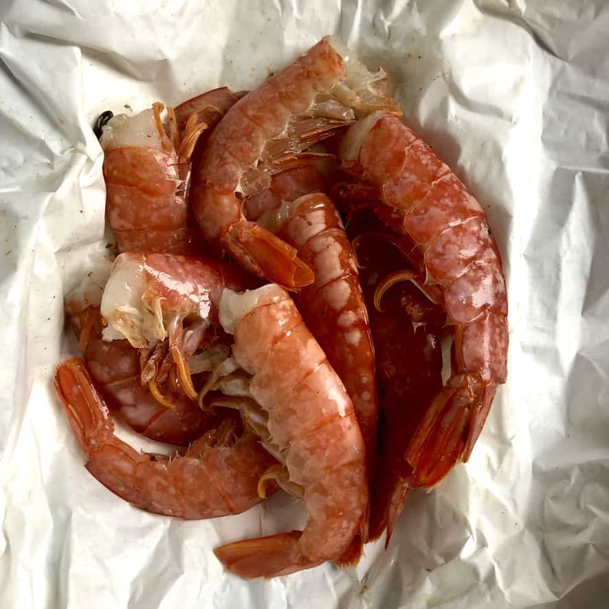 argentinian red shrimp with shells on white fishmonger paper