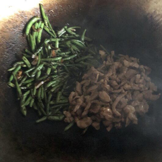 blistered green beans and the pork added back to the wok