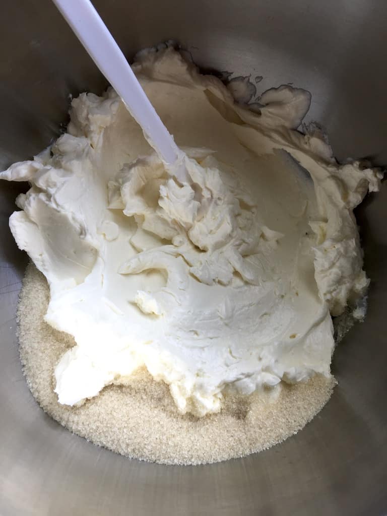 cream cheese with sugar in the bowl of a stand mixer