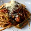 summer fresh tomato and zucchini pasta sprinkled with Grana Padano cheese