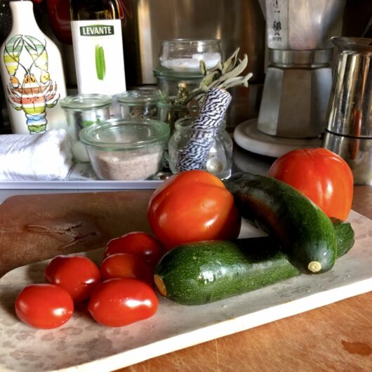 fresh tomatoes and zucchini on a platter
