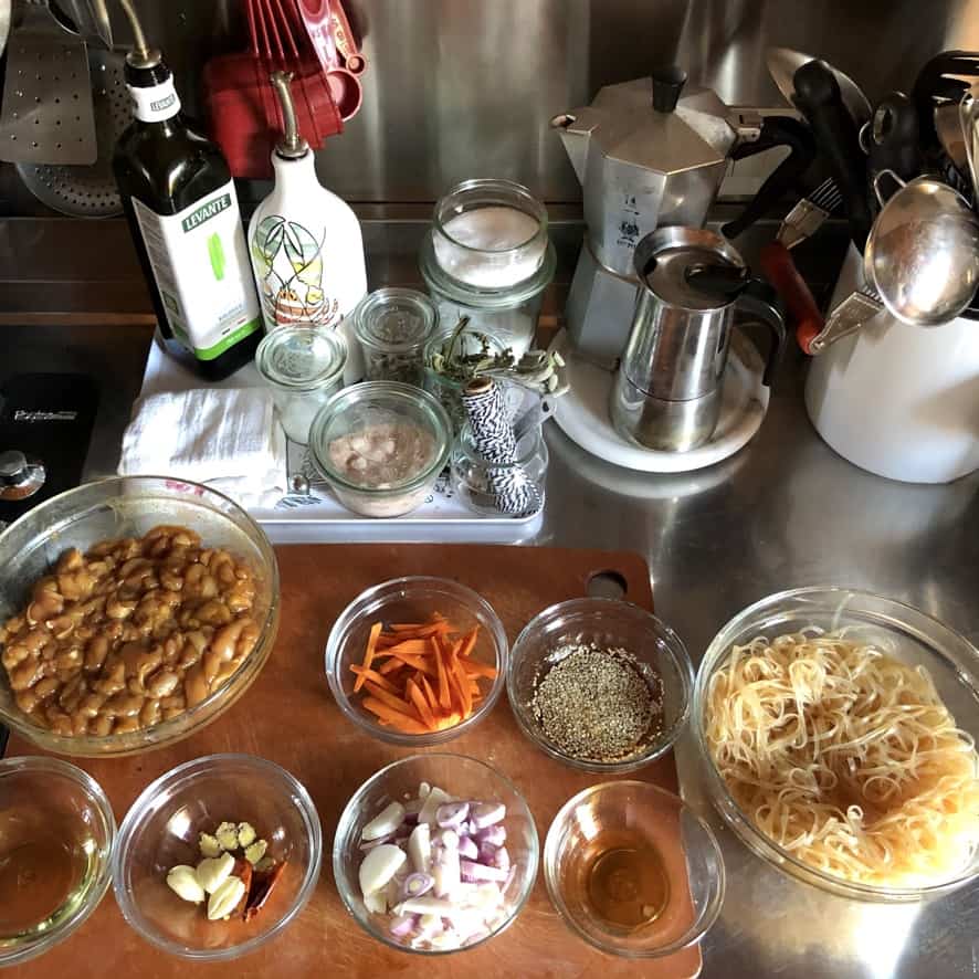 a bird's eye view of each chicken stir fry component in individual bowls assembled and ready to start stir frying