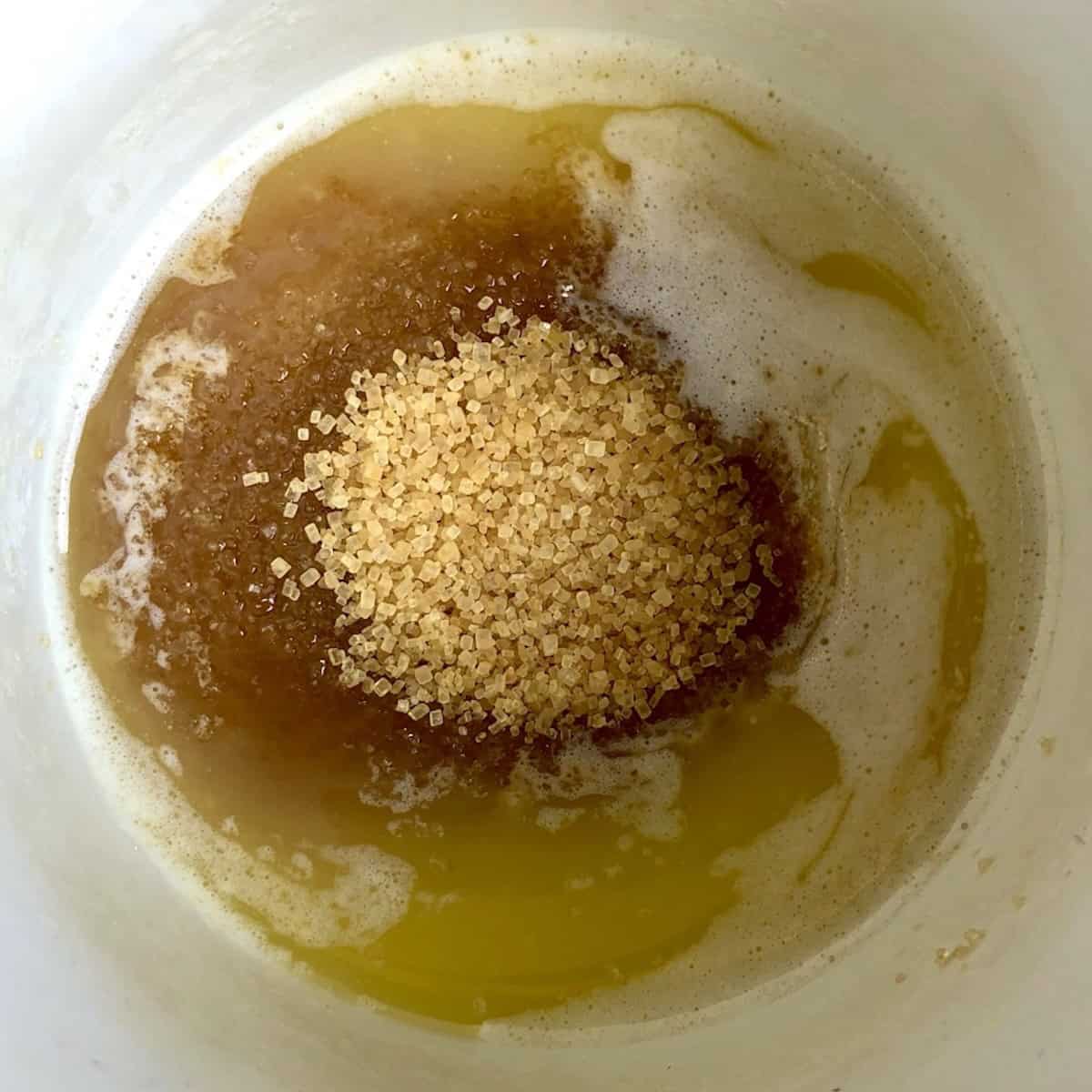 Melted butter, raw coarse sugar, and salt mixed together in a bowl for a crunchy pumpkin spice banana bread topping.