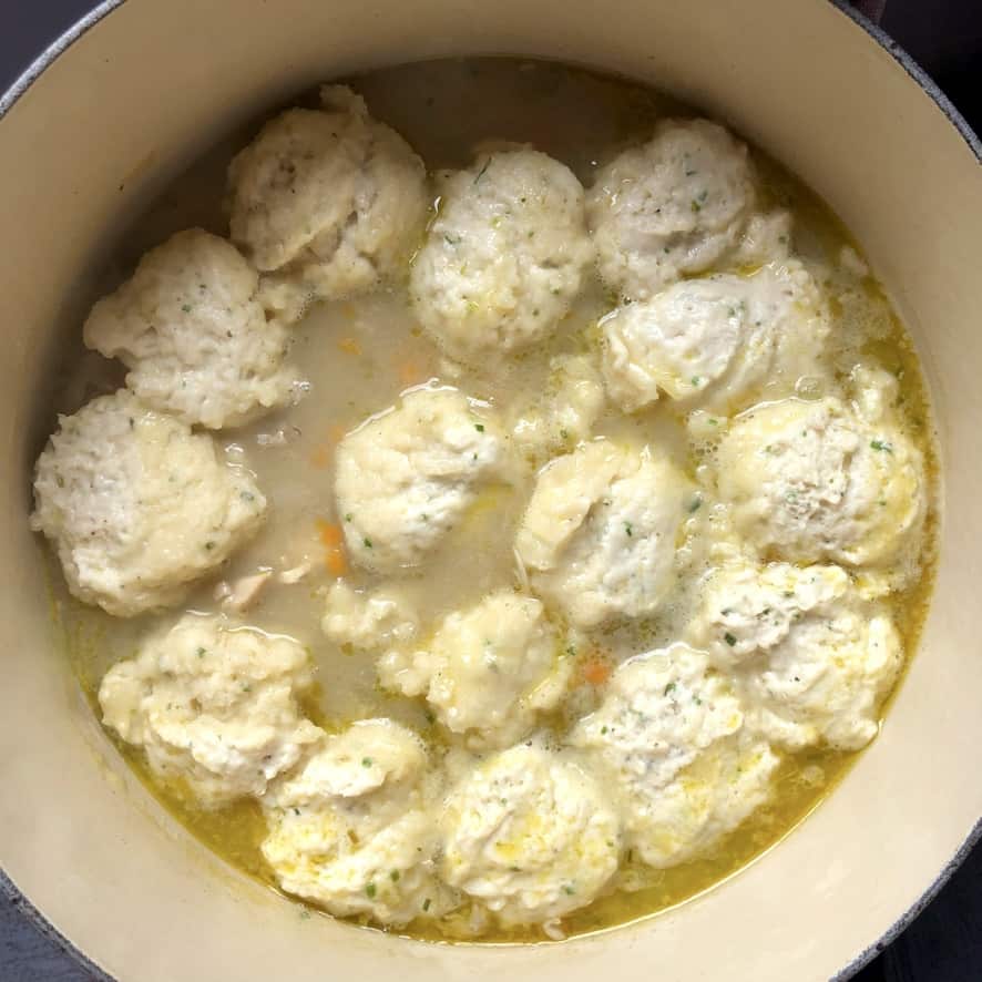 raw dumplings added to a homemade chicken soup base